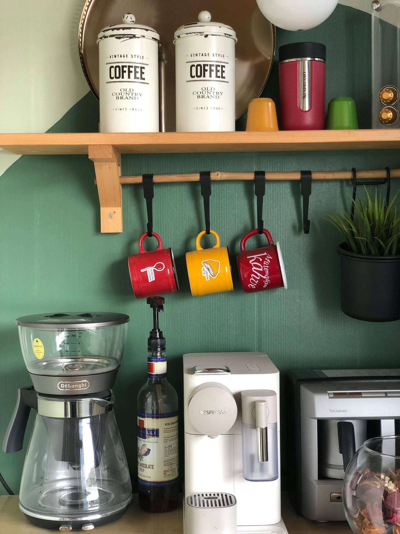A modern kitchen coffee corner built into the cabinetry run — the kind of dedicated station that anchors a coffee bar