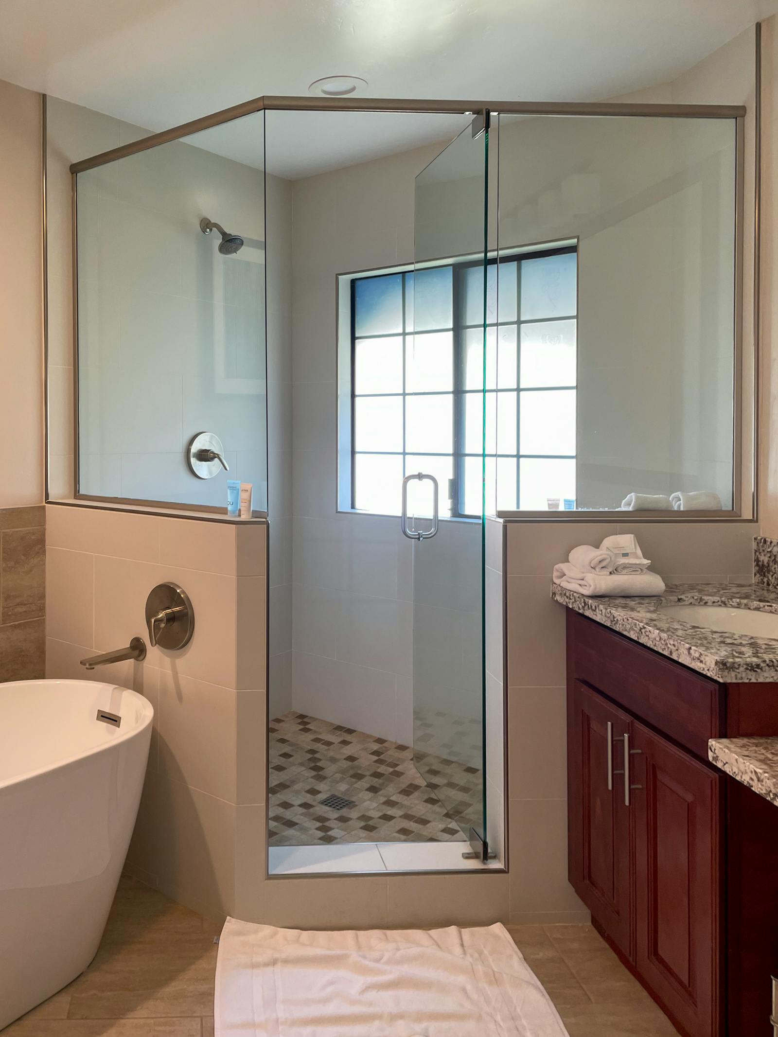 A modern tiled shower in a bright bathroom — a niche is a small, high-impact add to a tile job like this