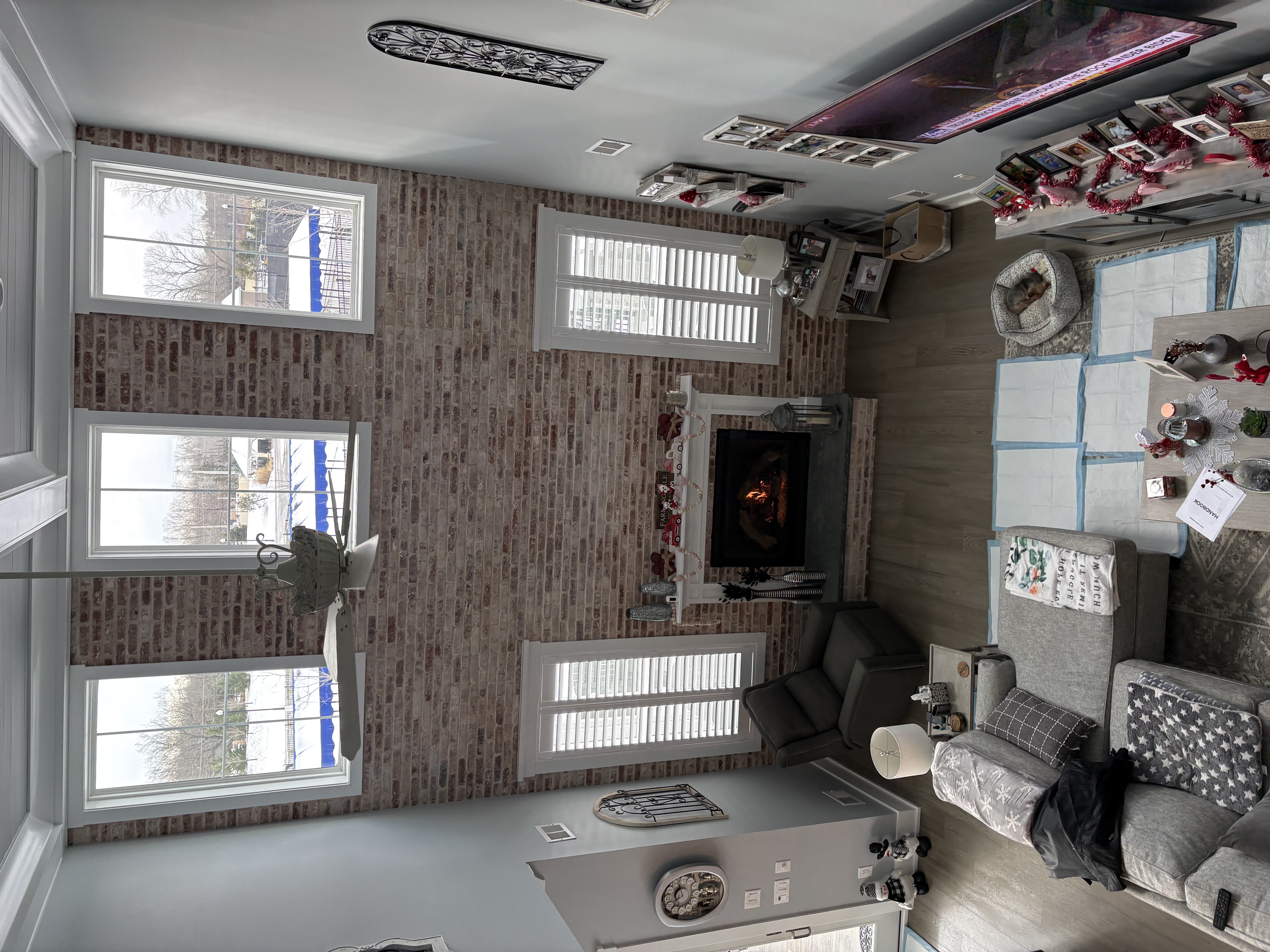 Living room renovation — brick fireplace accent wall with custom windows