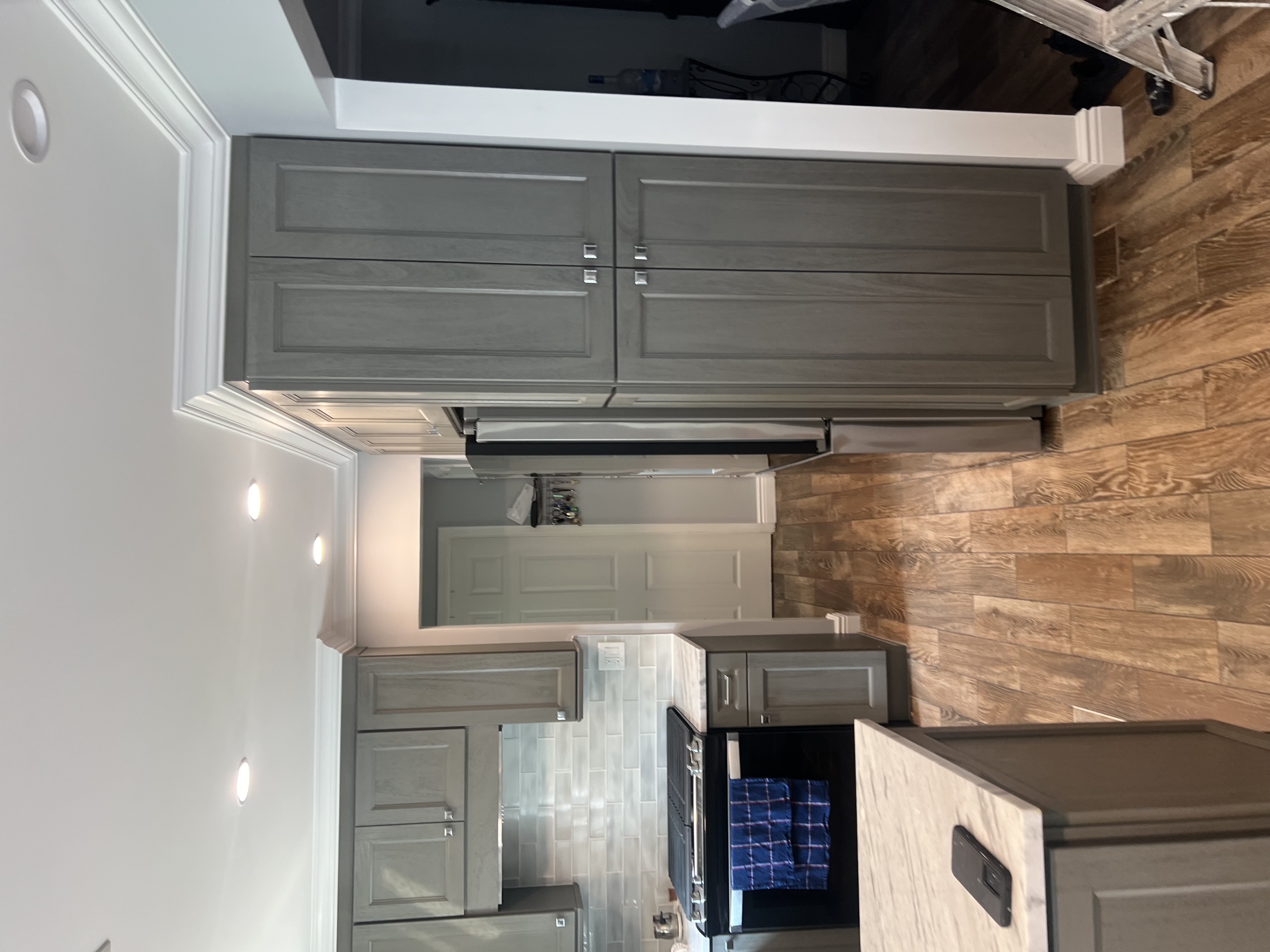 Floor-to-ceiling custom pantry and appliance wall with integrated storage in a luxury kitchen remodel